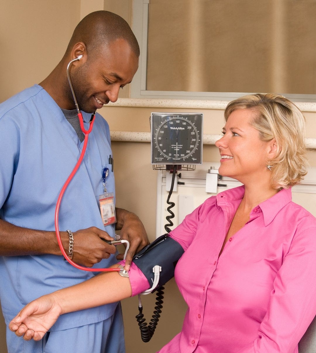 a doctor checking a patient's blood with a stethoscope