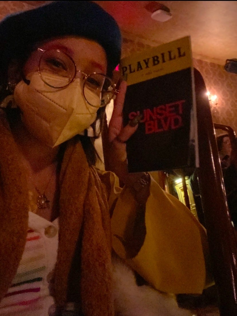 Kiana holding up a SUNSET BLVD playbill