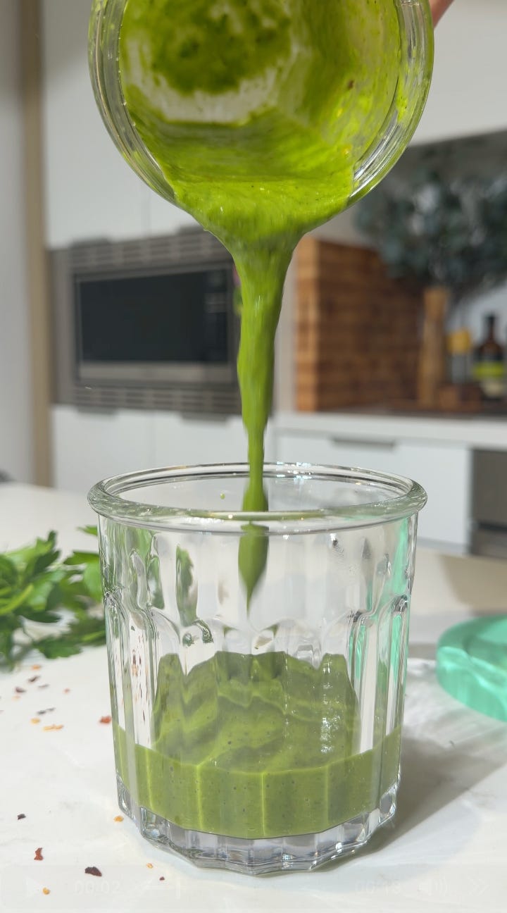Chimichurri salad dressing being poured into a glass jar