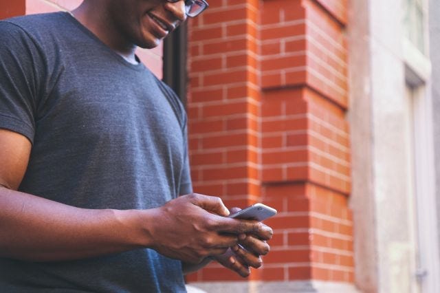 African american man texting on a smart phone