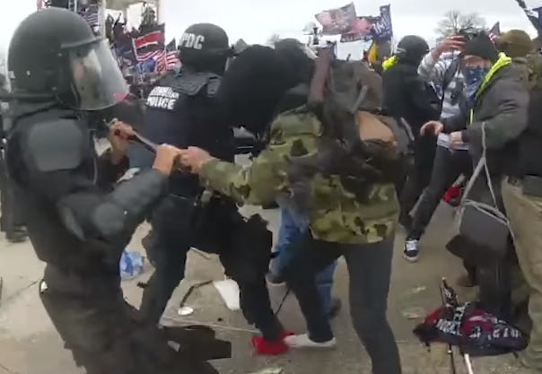 insurrectionists fighting police during the January 6 attack. insurrectionists fighting police during the January 6 attack.