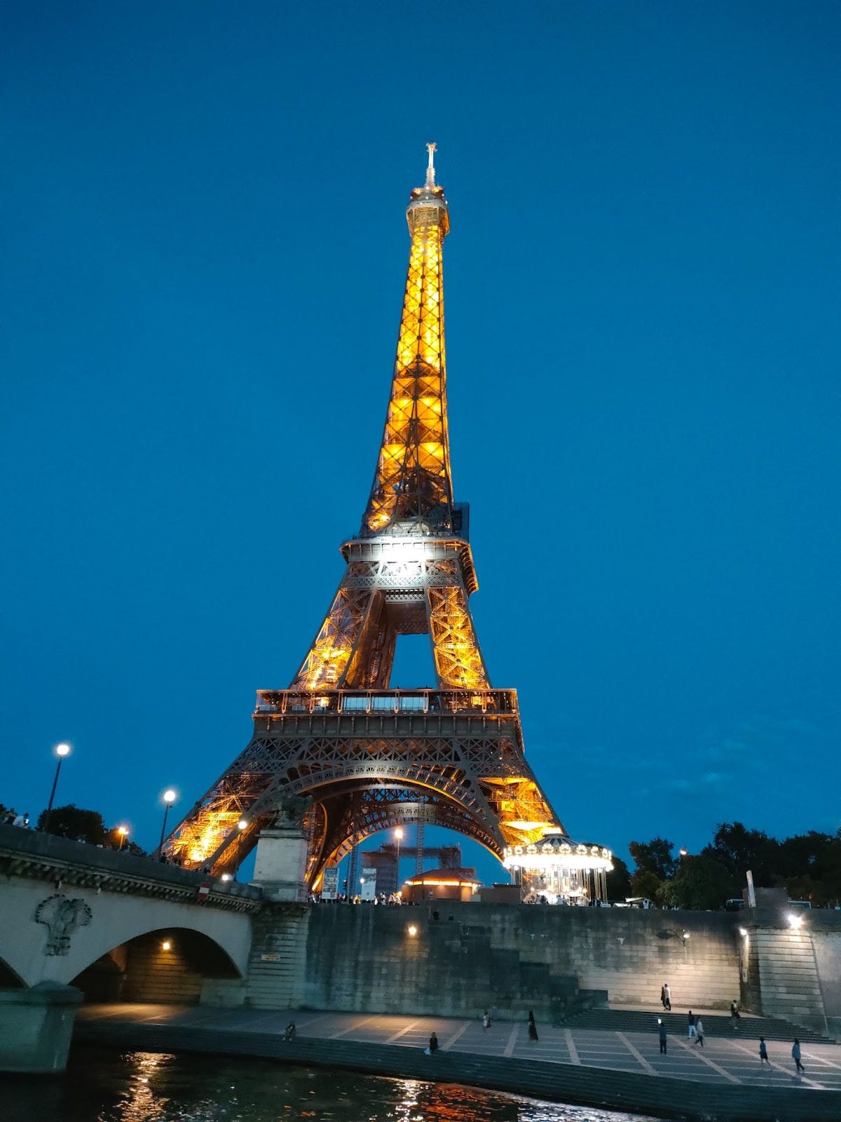 The Eiffel Tower sparkling with lights at night.