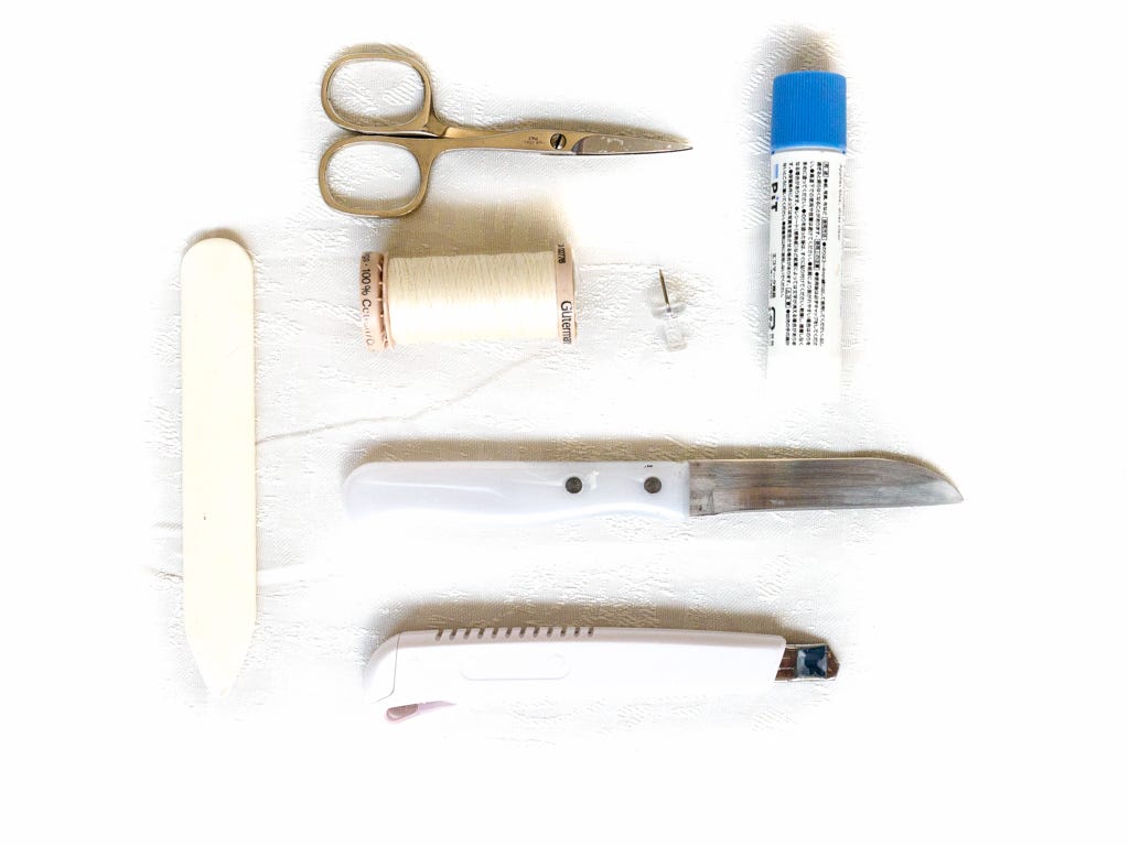scissors, thread, bone folder, knife