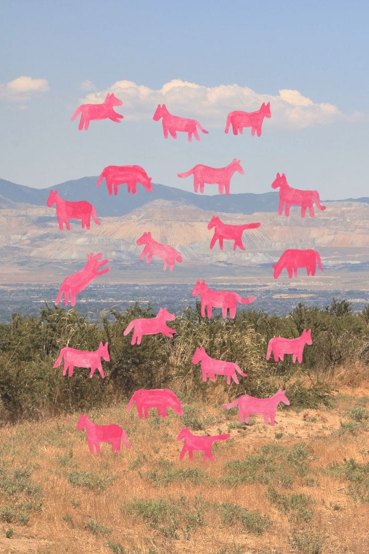 This may contain: pink horses are flying in the air over a field with mountains in the back ground
