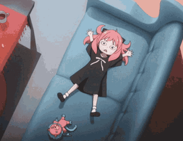 a girl with pink hair laying on a blue couch a girl with pink hair laying on a blue couch