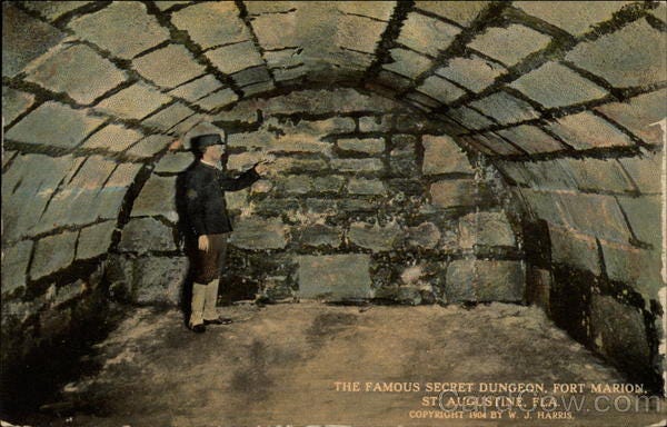 A person standing in a stone tunnel

Description automatically generated