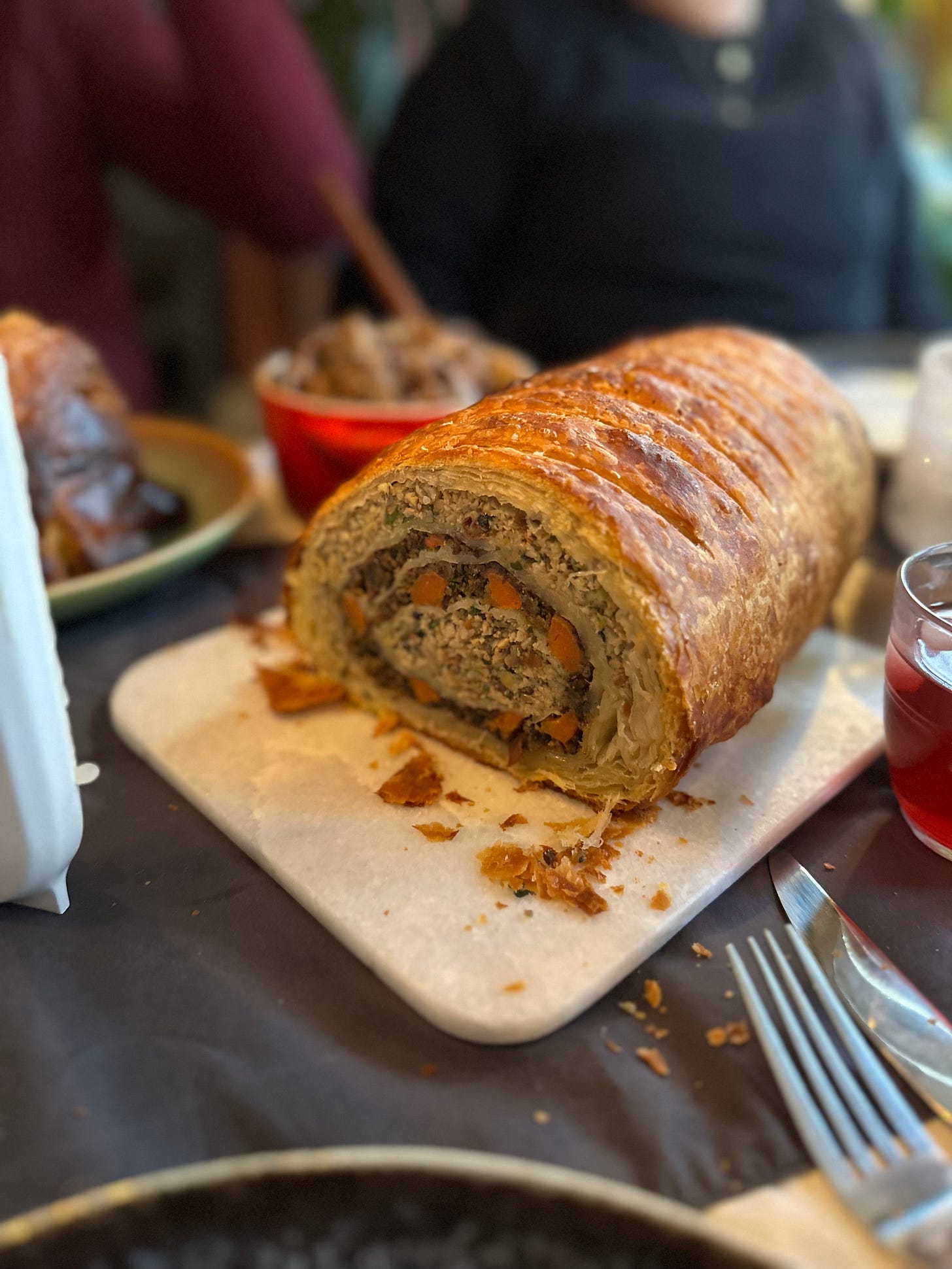 a mushroom and carrot wellington, on a festive table