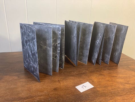 folded paper fanned out in various shades of blue.