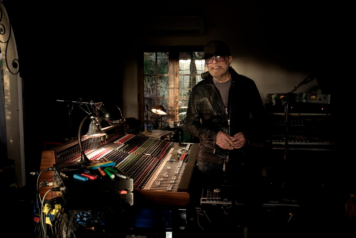 Daniel Lanois in his studio surrounded by mixing consoles and recording equipment - photo by Marthe Vannebo
