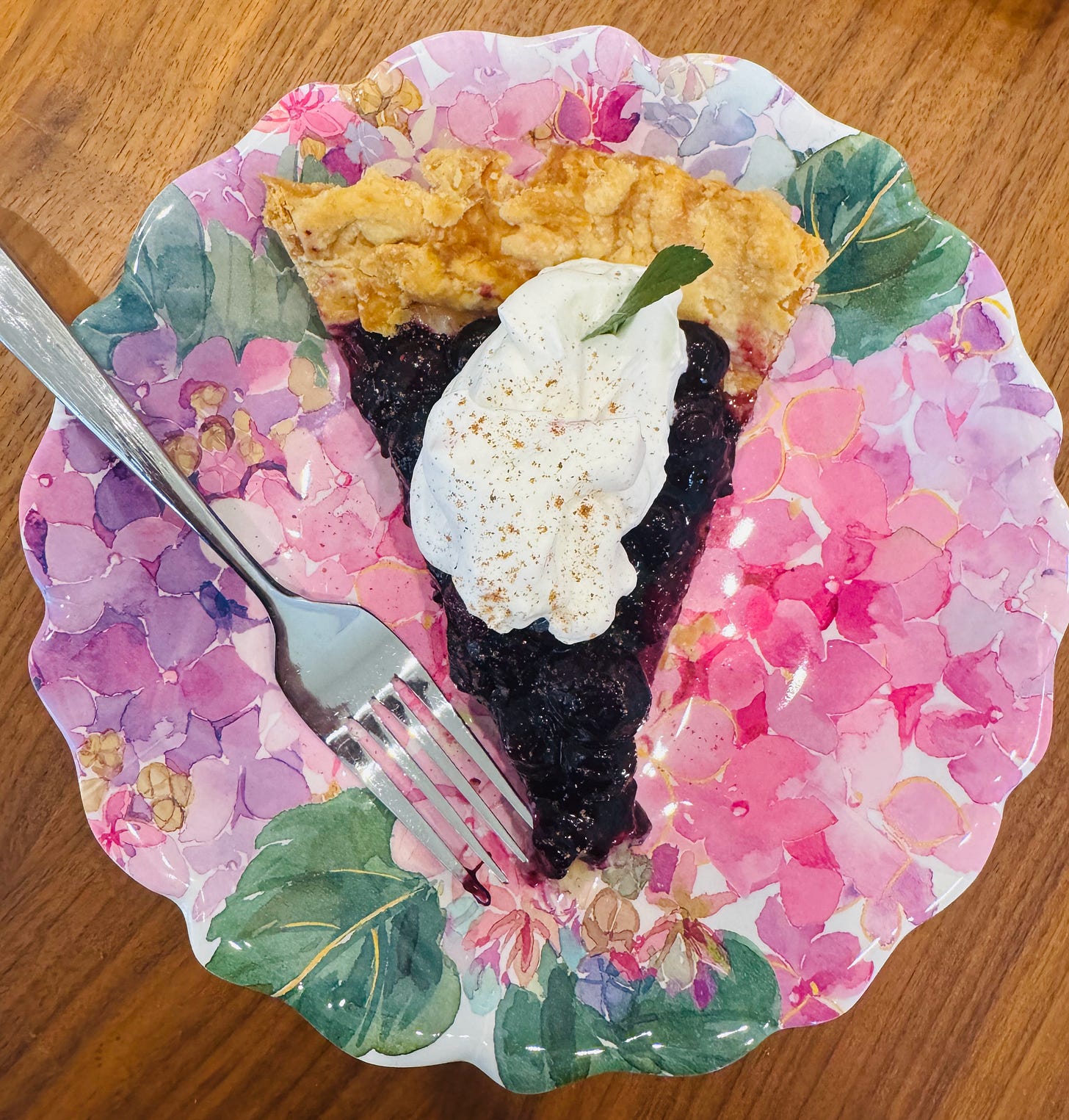 A slice of Helen's Old Fashioned cream pie with blueberry compote, whipped cream, nutmeg, and a sprig of mint. A slice of Helen's Old Fashioned cream pie with blueberry compote, whipped cream, nutmeg, and a sprig of mint.