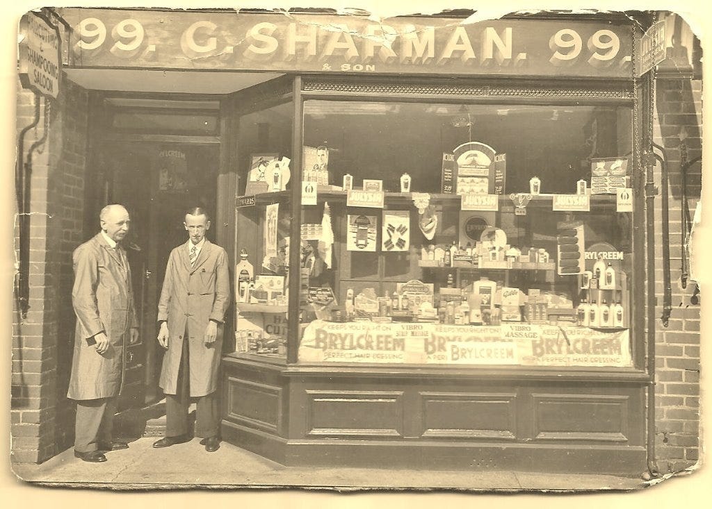 George Henry Sharman outside his hairdresser's shop at 99 Vicarage Road, Watford
