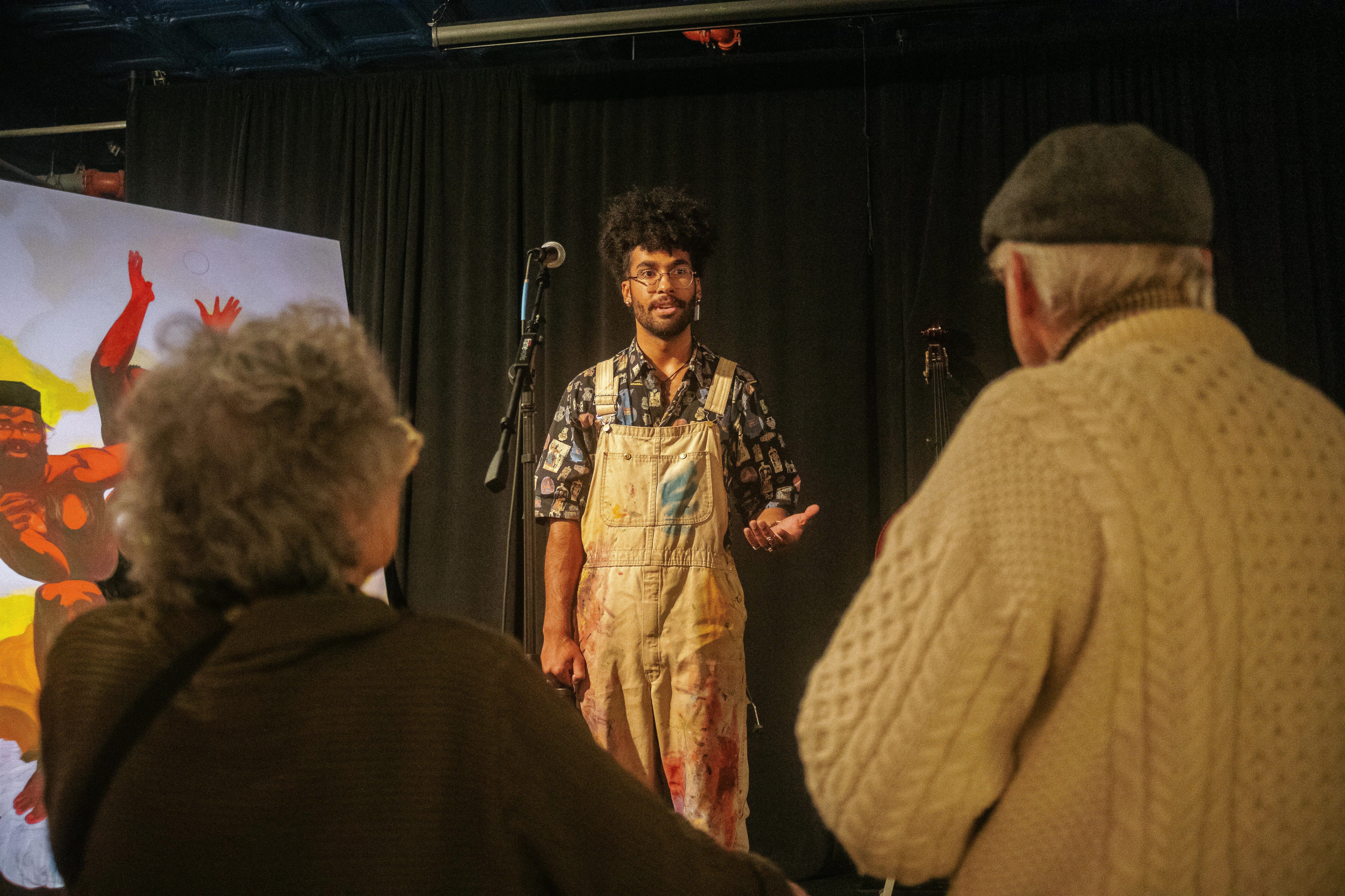 Images of Inde Francis, featured artist, interacting with paintings and people at live performance art event