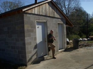 This man is very proud of his new smokehouse.