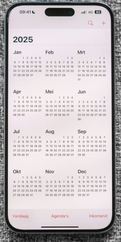 A white and black phone sitting on top of a gray surface