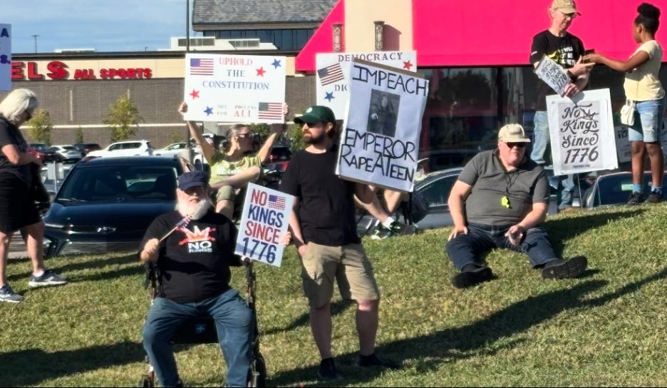 A group of people holding signs

AI-generated content may be incorrect.