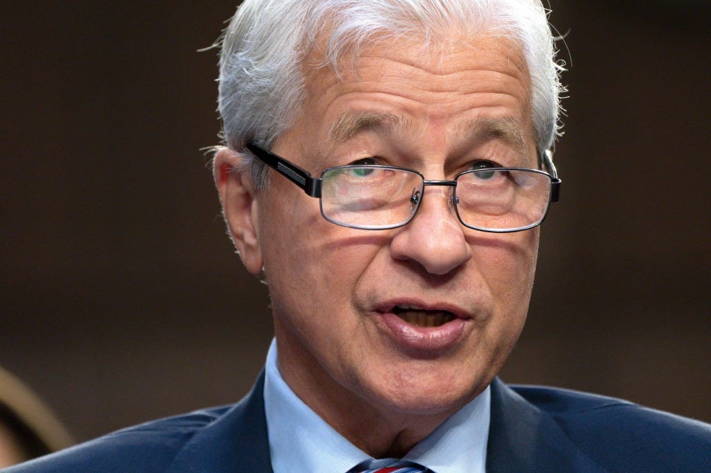 A headshot of JP Morgan CEO Jamie DImon wearing glasses and looking serious. A headshot of JP Morgan CEO Jamie DImon wearing glasses and looking serious.
