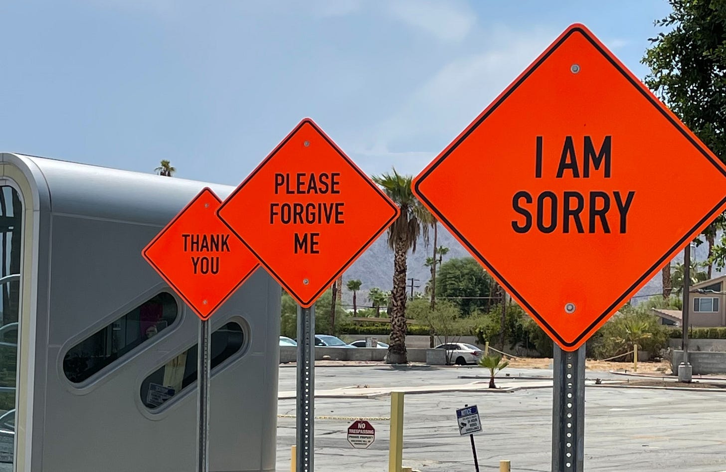 Street signs that say "I'm sorry", "Please forgive me" and "thank you"