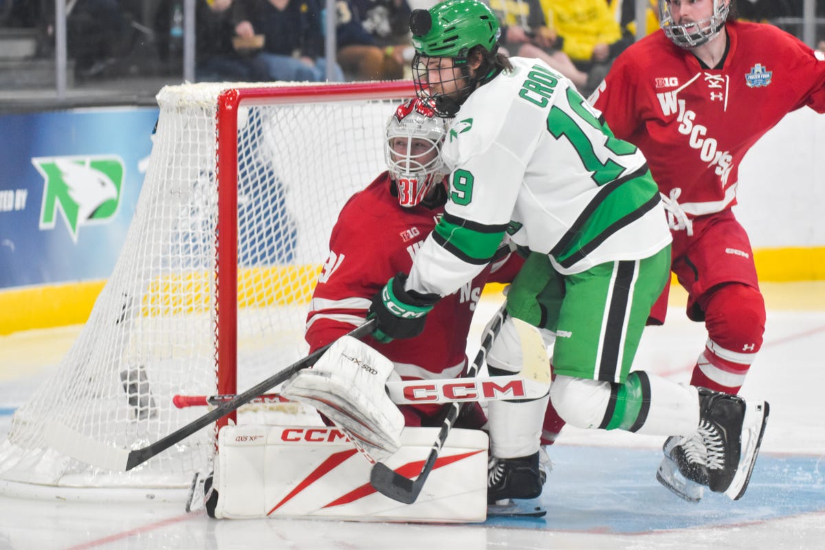 Daniel Hauser turns to his right as a puck hits Cody Croal in the helmet
