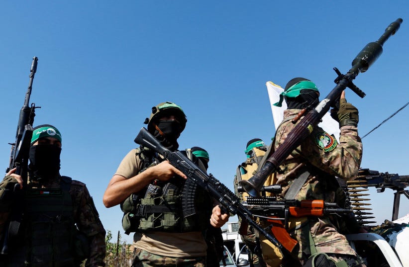 Palestinian fighters from the armed wing of Hamas take part in a military parade to mark the anniversary of the 2014 war with Israel, near the border in the central Gaza Strip, July 19, 2023. (photo credit: REUTERS/IBRAHEEM ABU MUSTAFA) Palestinian fighters from the armed wing of Hamas take part in a military parade to mark the anniversary of the 2014 war with Israel, near the border in the central Gaza Strip, July 19, 2023. (photo credit: REUTERS/IBRAHEEM ABU MUSTAFA)