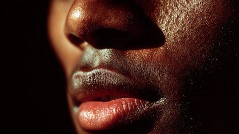 A six-image gallery showing close-up studies of Black lips in color and black-and-white, some parted as if mid-breath; silhouetted figures standing in architectural spaces divided by light and shadow; and abstract, glowing cellular forms resembling blood cells. The images move between intimacy and distance, echoing themes of voice, restraint, and survival under observation.