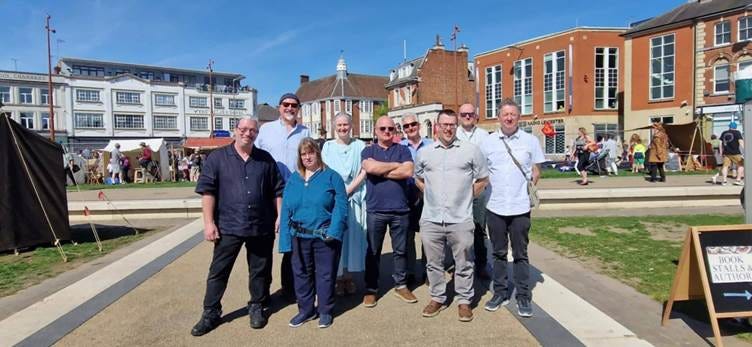 A group of people posing for a photo

AI-generated content may be incorrect.