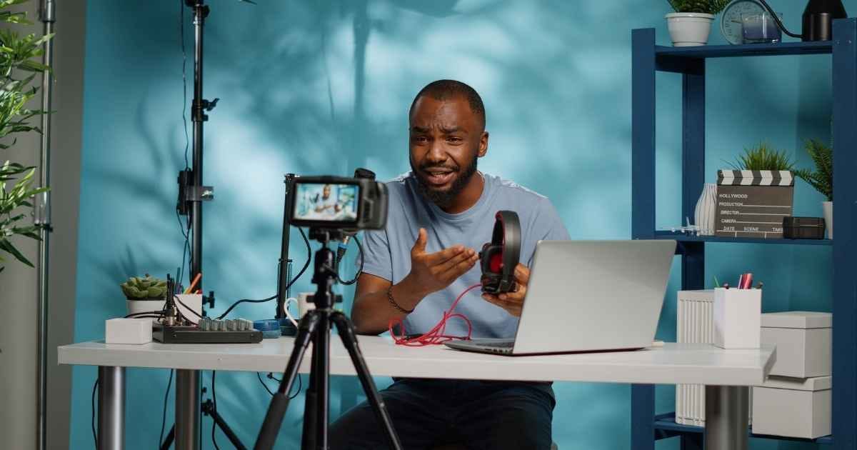 content creator holding headphones for product review