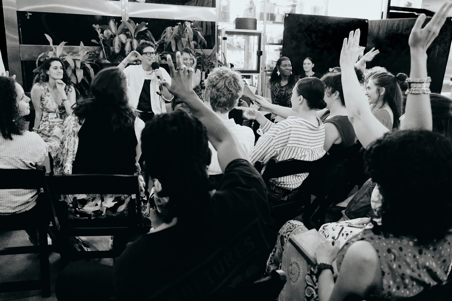 Dreamers raise their hands during Dreams & Obstacles NYC 1 at Farm.One in Brooklyn.