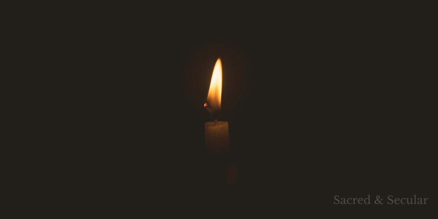 A lit candle in darkness A lit candle in darkness