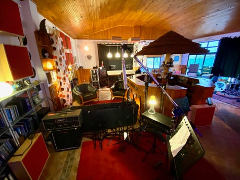 Musical equipment and people inside a recording studio