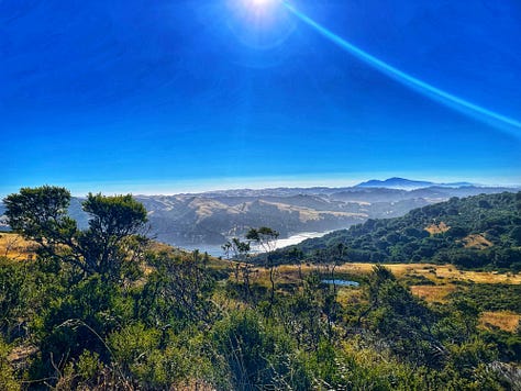 California landscape with hills and a blue sky, family photo in a gondola above Lisbon, view out the airplane window of the sunset