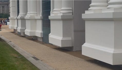 Fake stone columns end several inches above the ground.
