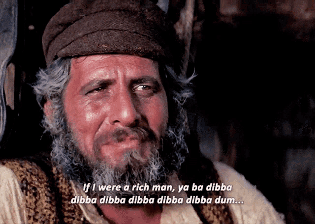 a man with a beard and hat says if i were a rich man ya ba dibba dibba dibba dibba dibba dum