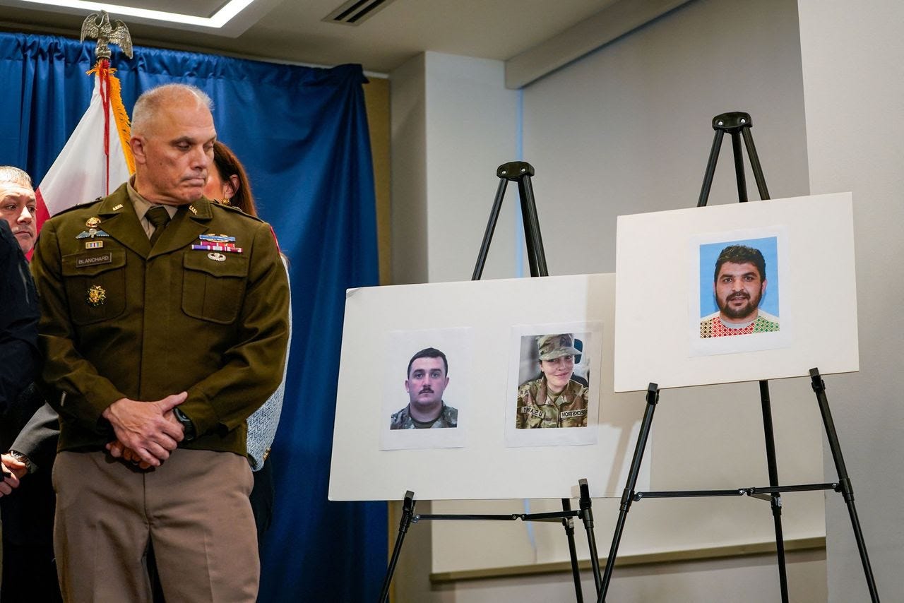 Brig. Gen. Leland D. Blanchard II with pictures of two National Guard members who were shot last week in D.C. and a photo of the suspect, Rahmanullah Lakanwal. (Nathan Howard/Reuters)