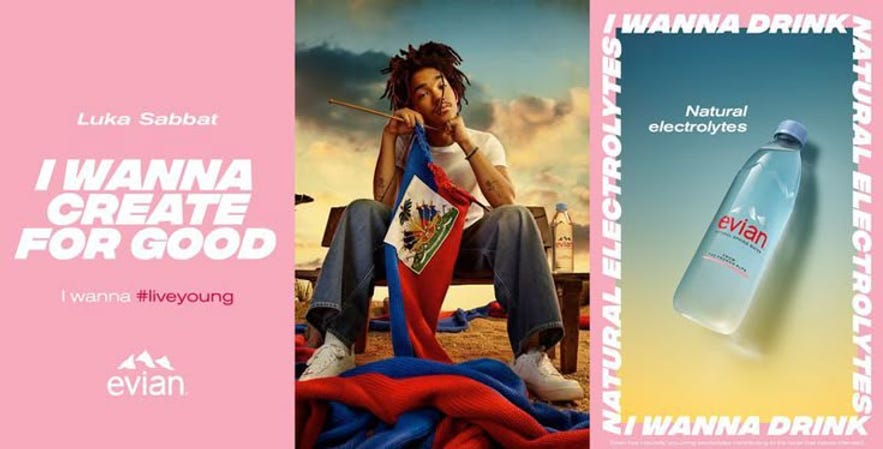 Luka Sabbat sitting with a flag, knitting in a serene outdoor setting. Text: "I WANNA CREATE FOR GOOD" and "evian" in pink. Evian bottle on right.