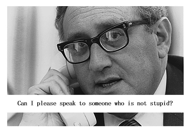 Image with the description: Secretary of State Henry A. Kissinger uses the telephone in Deputy National Security Advisor Brent Scowcroft's office to get the latest information on the situation in South Vietnam.  Across the bottom of the picture is a white band with the caption: Can I please speak with someone who is not stupid?