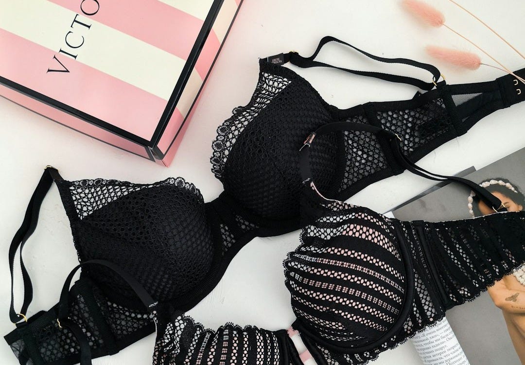 black lace brassiere on white table black lace brassiere on white table
