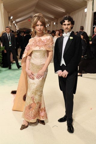 Image may contain Person Adult Wedding Clothing Formal Wear Suit Accessories Tie Footwear High Heel and Shoe