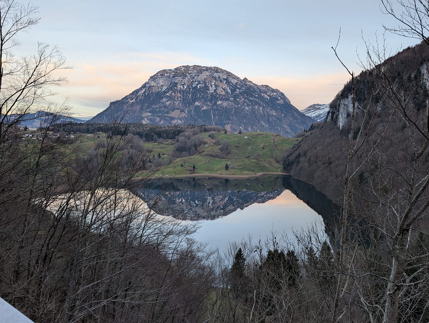 A still, alpine lake, reflecting a nearby mountain A still, alpine lake, reflecting a nearby mountain