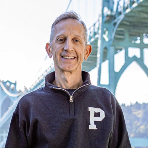 Keith Wilson standing in Cathedral Park in Portland, Oregon 