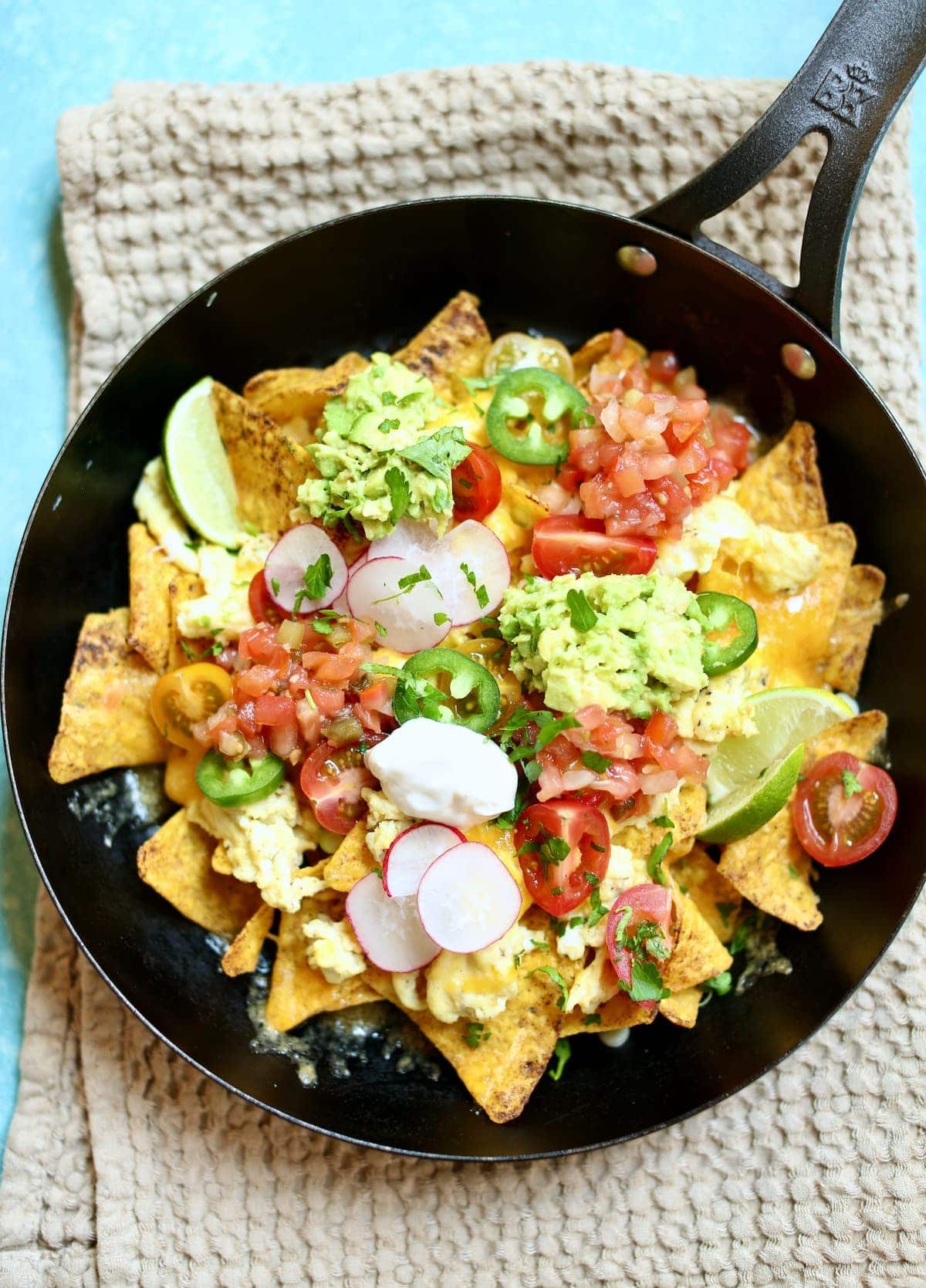a close up photo of a skillet of nachos.