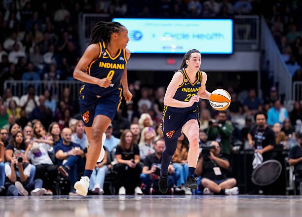 Caitlin Clark and Kelsey Mitchell of the Indiana Fever bring the ball up the floor against the Toronto Tempo during the first half in their WNBA game... Caitlin Clark and Kelsey Mitchell of the Indiana Fever bring the ball up the floor against the Toronto Tempo during the first half in their WNBA game...