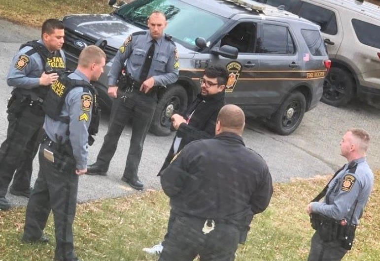 Danesh Noshirvan being questioned by the police.
