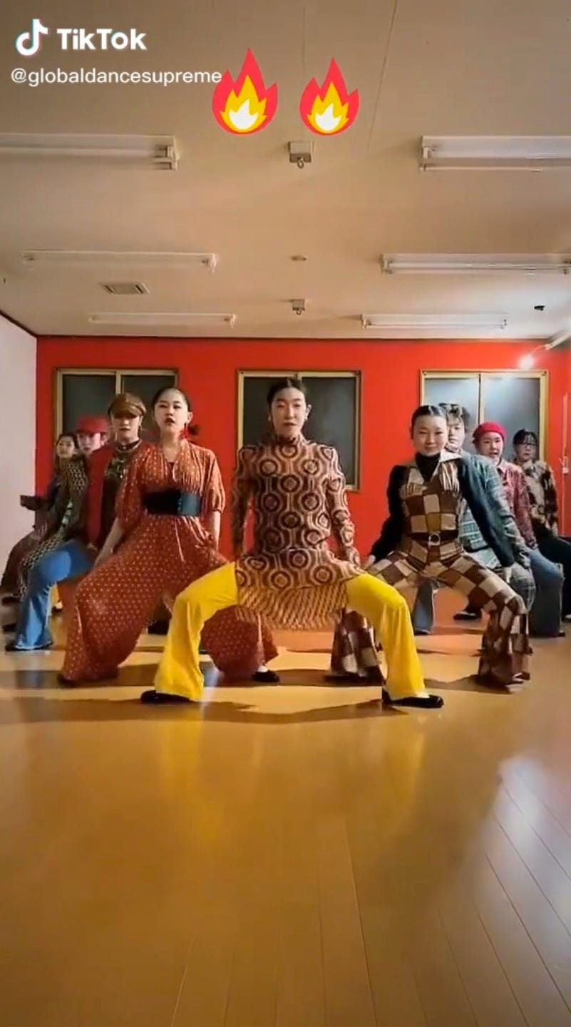 Screenshot of a TikTok video showing a group of Japanese dancers performing to the James Brown song, "Gonna Have a Funky Good Time".