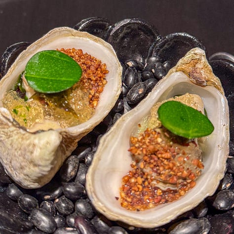 Amuses bouches including poached oysters, puffed bread and goat cheese tartelette at Virtus restaurant, Paris