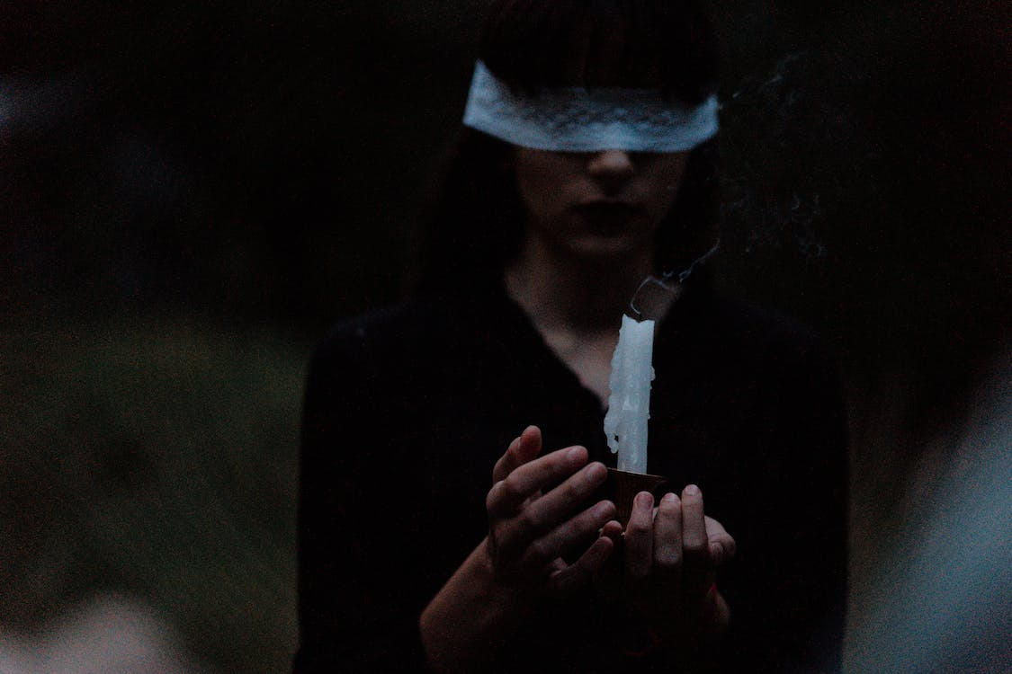 Free Blindfolded Woman With a Candle Stock Photo