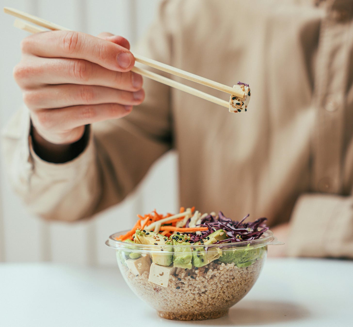 person eating small bowl of food person eating small bowl of food