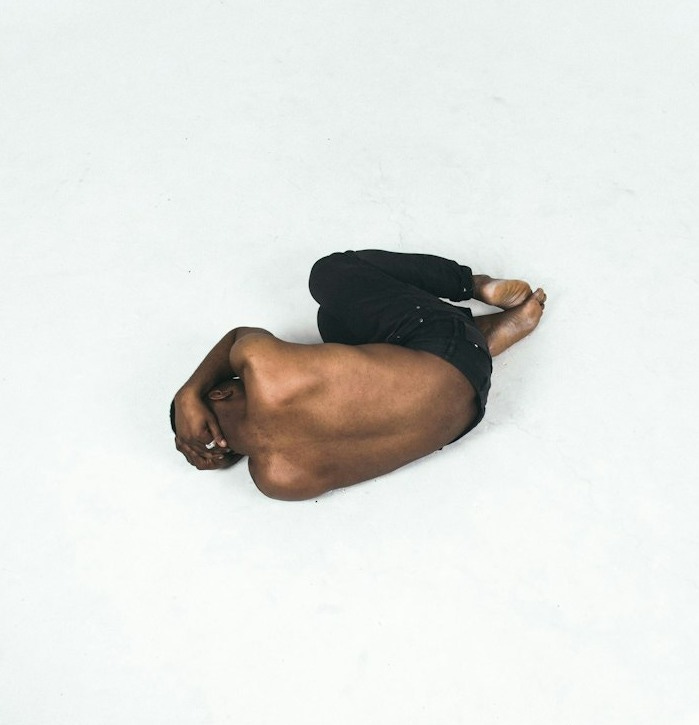 person lying down on white surface