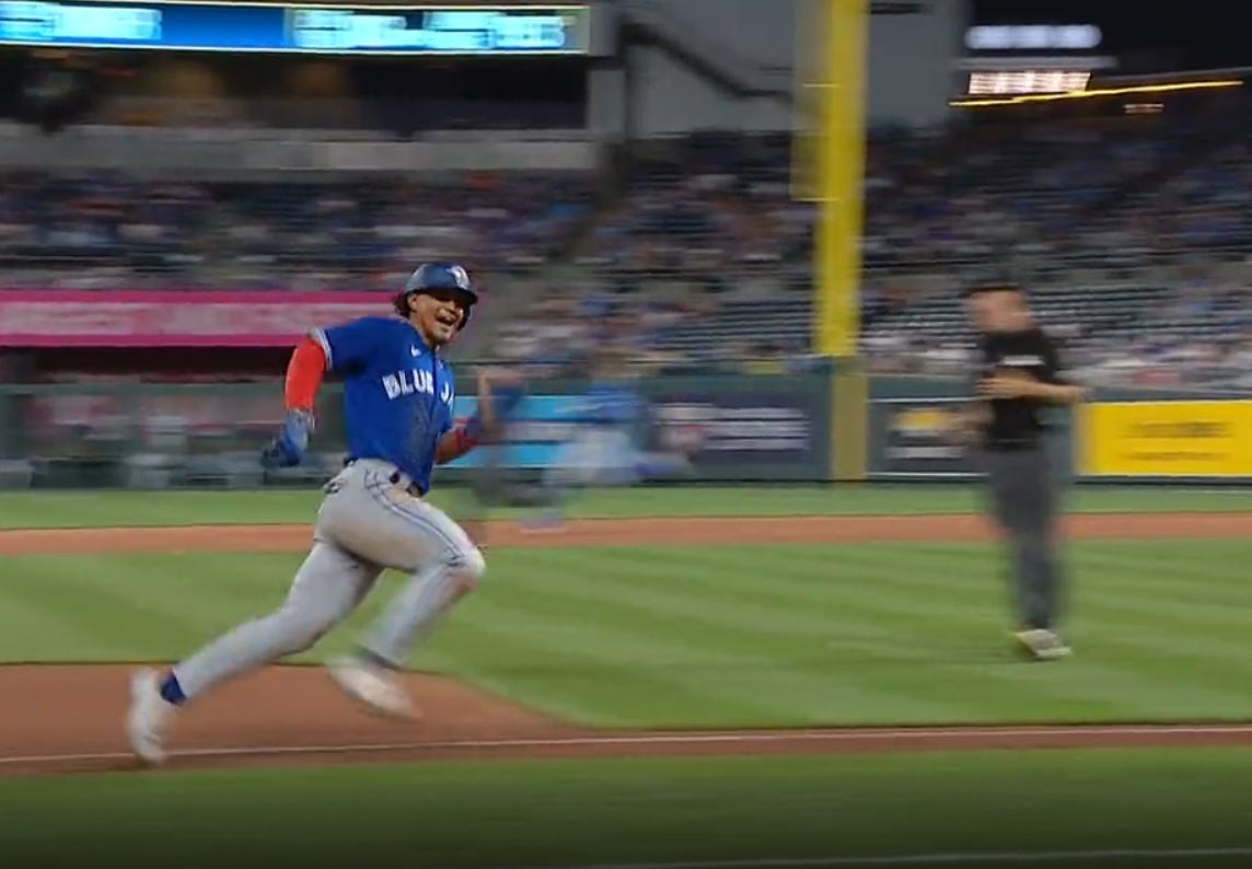 Santiago Espinal smiles at his teammates in the dugout as he rounds third to score on Raimel Tapia's two-out double in the 7th inning to make the game 3-0.