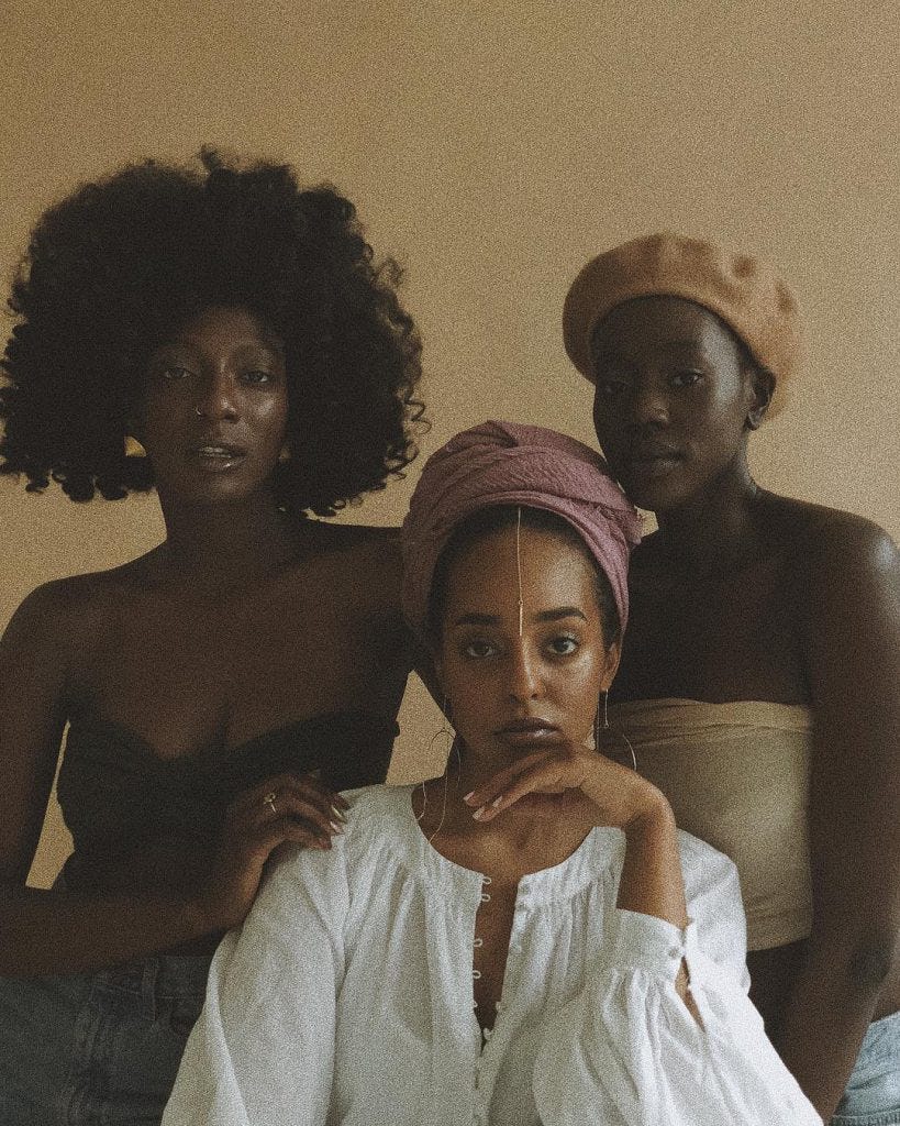Three women stand together