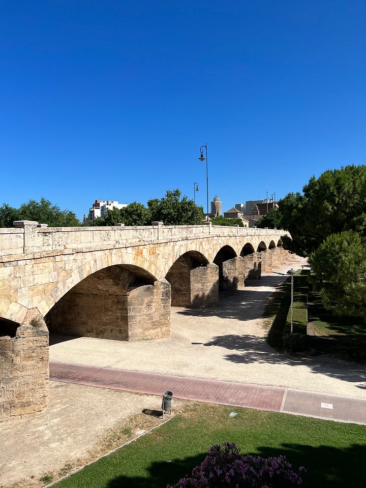 Historic bridge (top left), bicycle in russafa neighborhood (top right), myself at the city of arts and science (bottom left), bicycle in front of shop (bottom right)